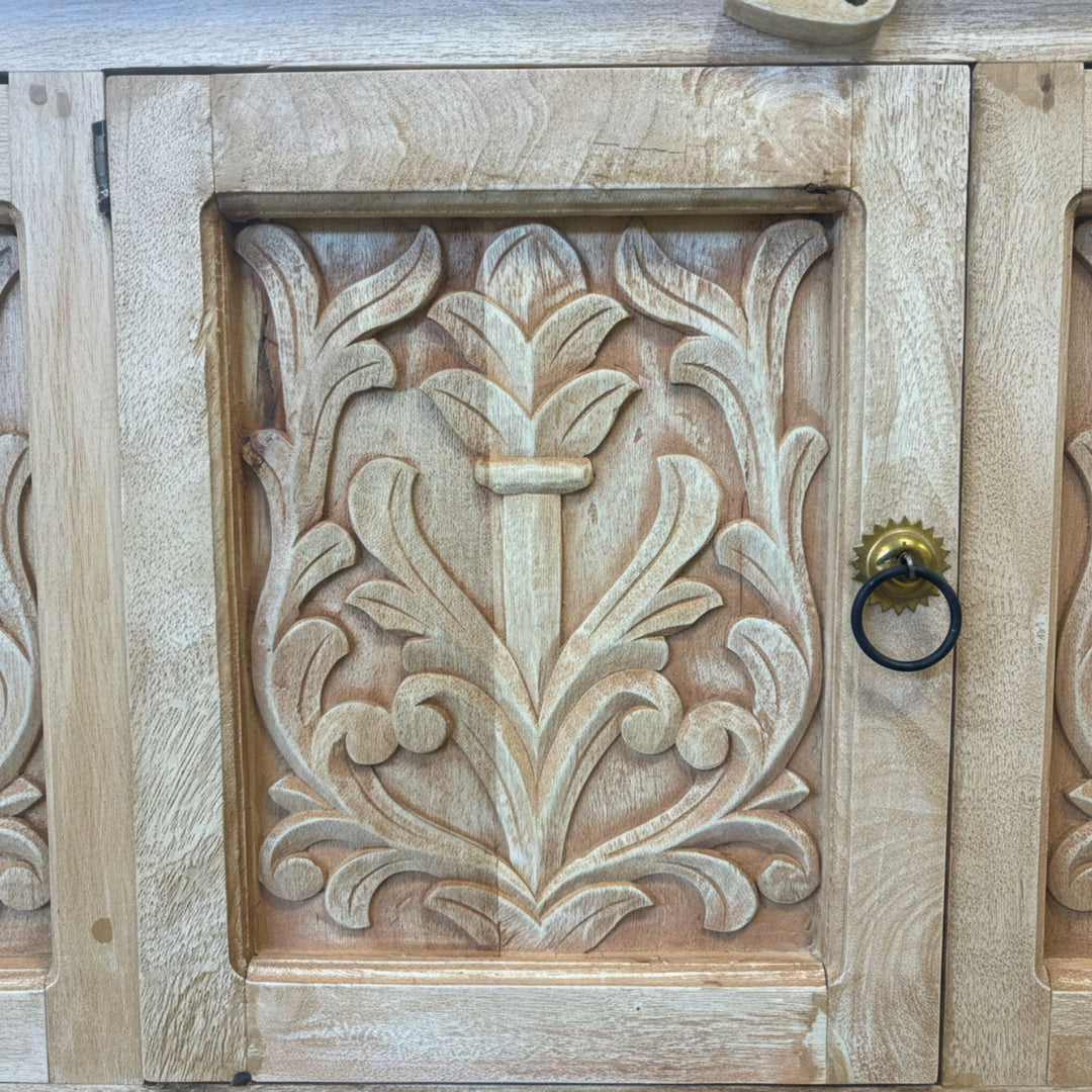 Detailed view of the metal handles and carved wood textures.