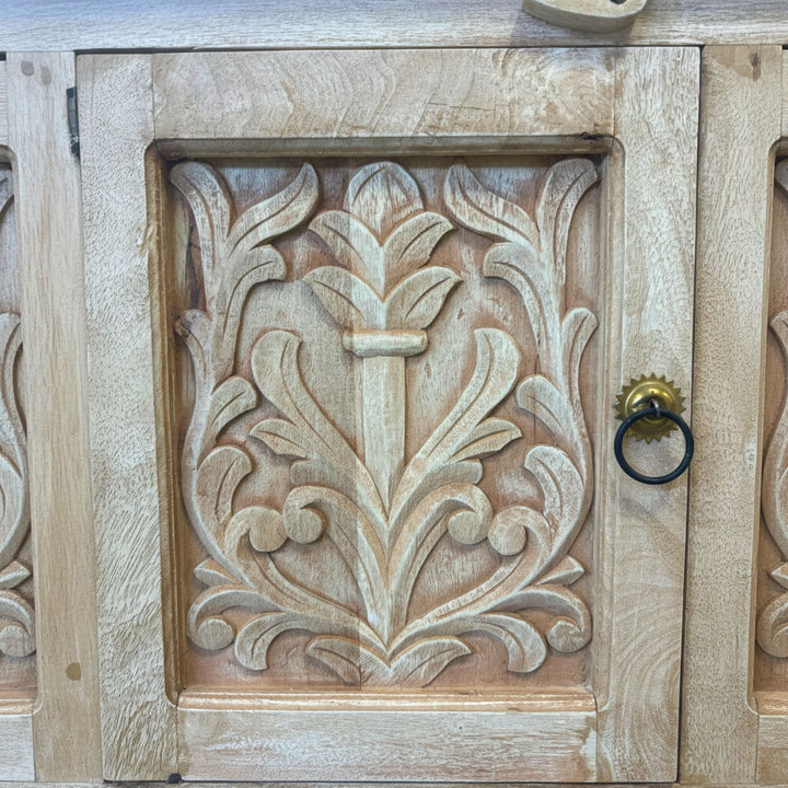 Detailed view of the metal handles and carved wood textures.