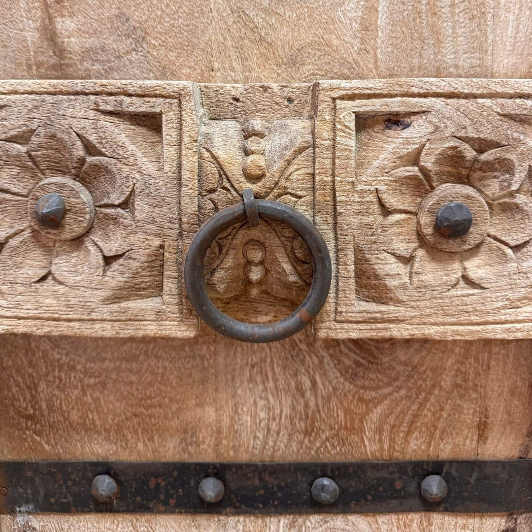 Close-up of the carved wooden doors and handcrafted details on the White Briss buffet.