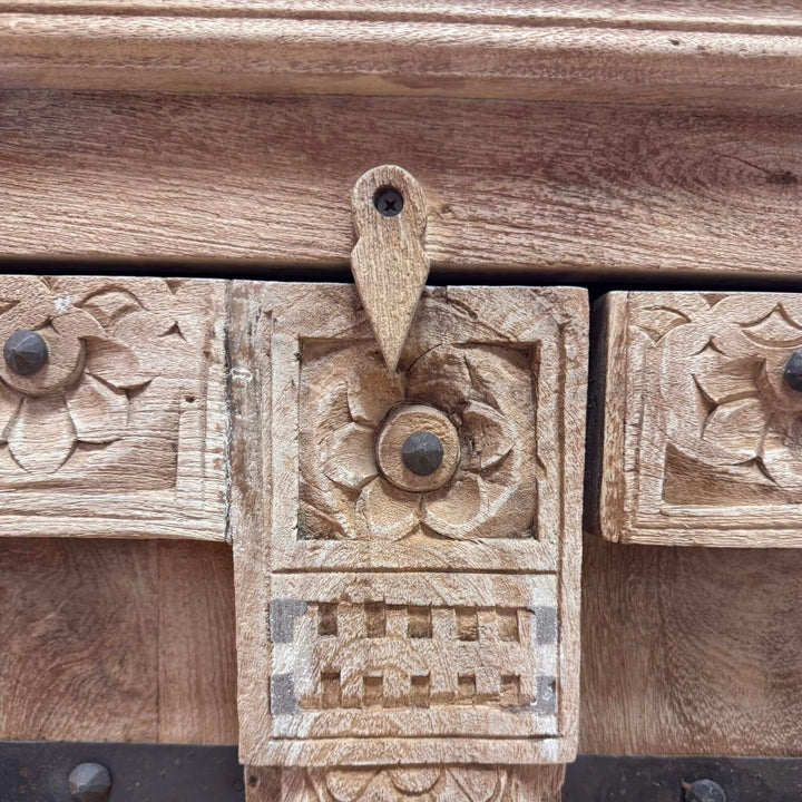 Detailed texture shot displaying the natural grain and artisanal carving of the sheesham wood.
