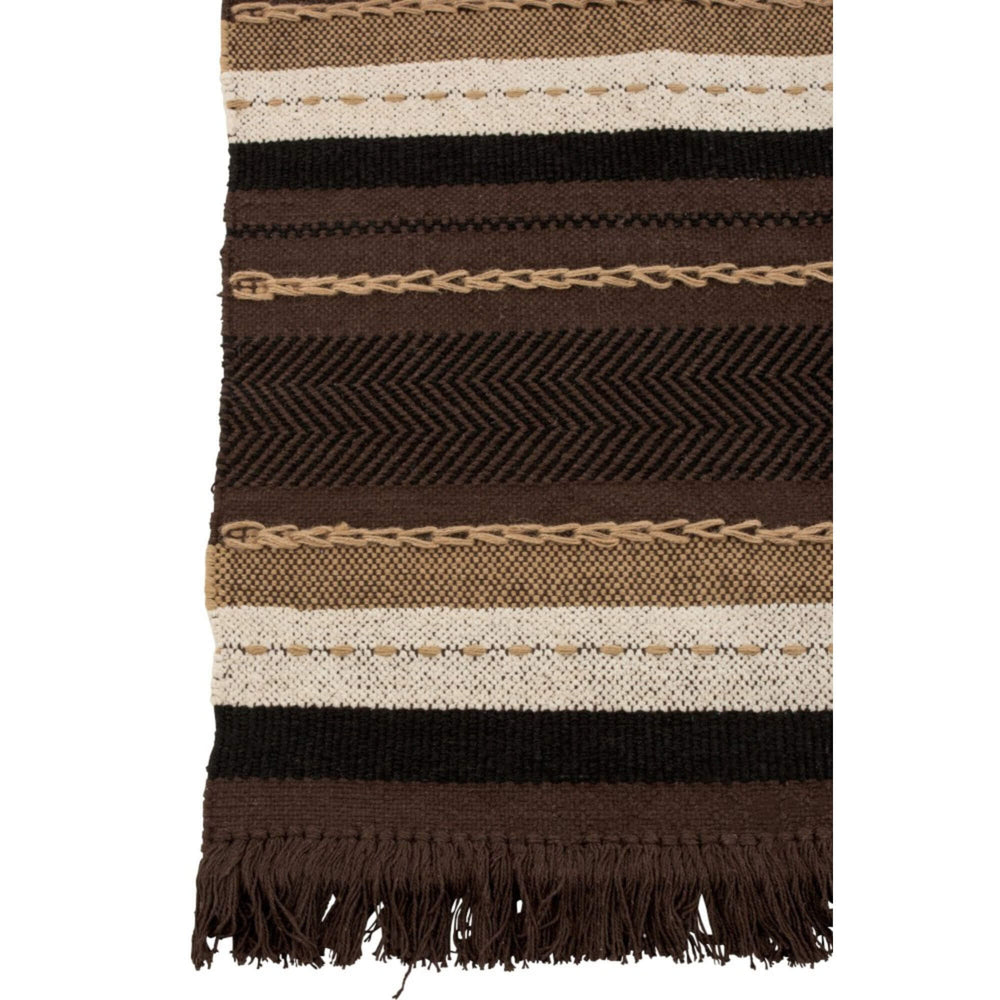 Buga cotton plaid close-up showing woven striped pattern in brown and beige with fringe detail.