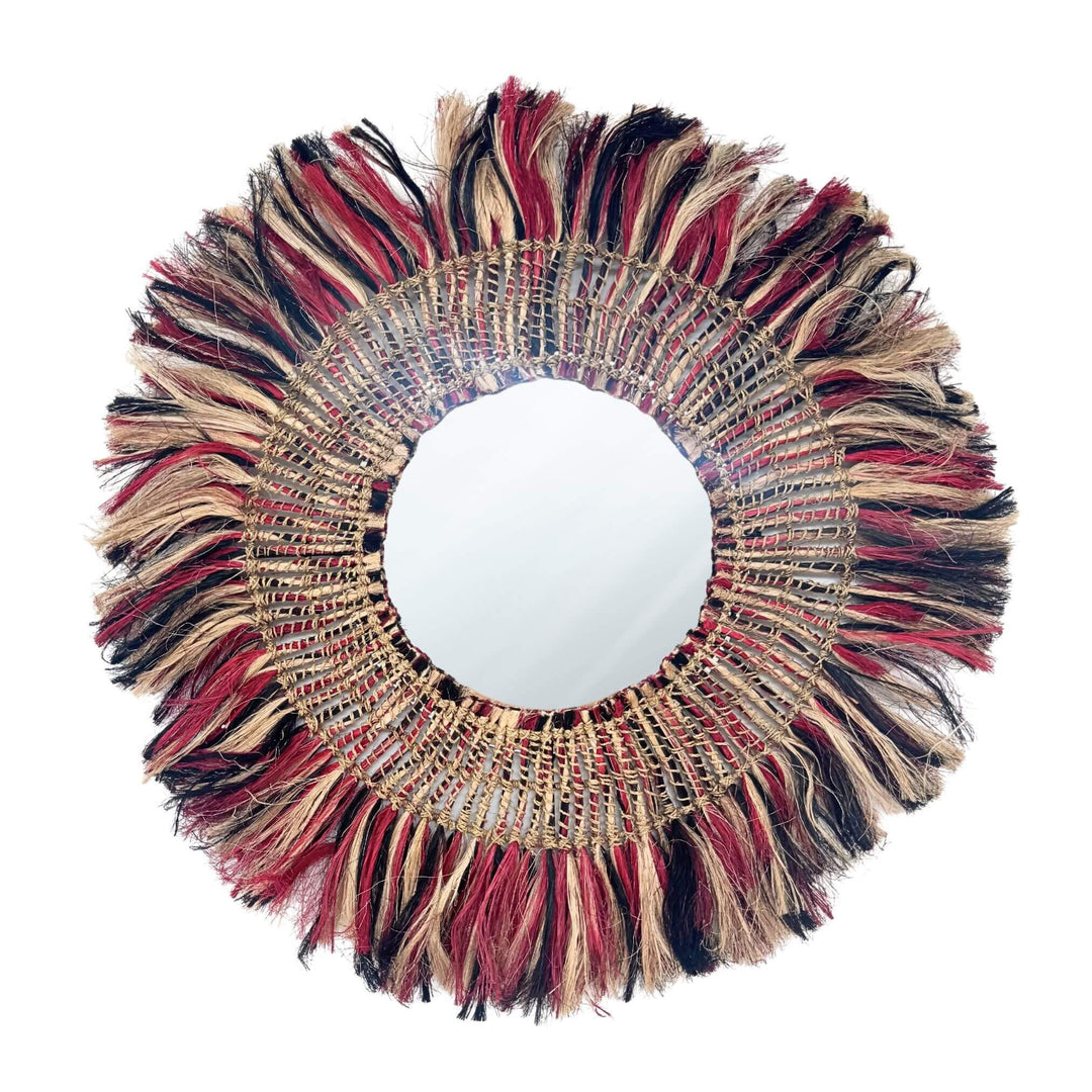 Bayu Mirror 85 cm with abaca fringe in red, black and beige on white background.