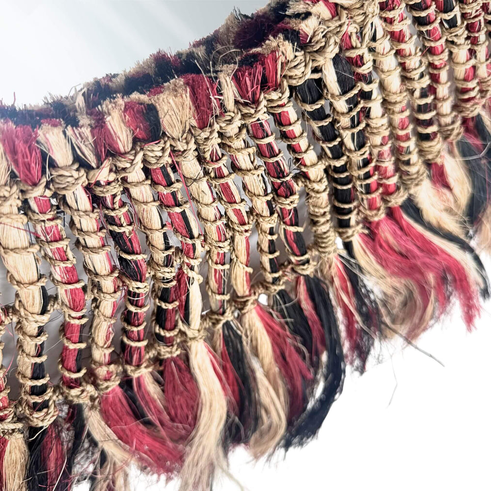 Close-up of Bayu Mirror woven frame showing colorful abaca and natural fiber details.