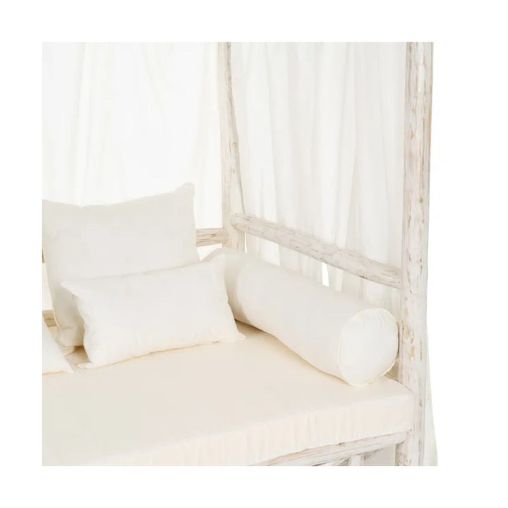 Interior view of Cahya teak daybed showing cushions and side bolster pillows