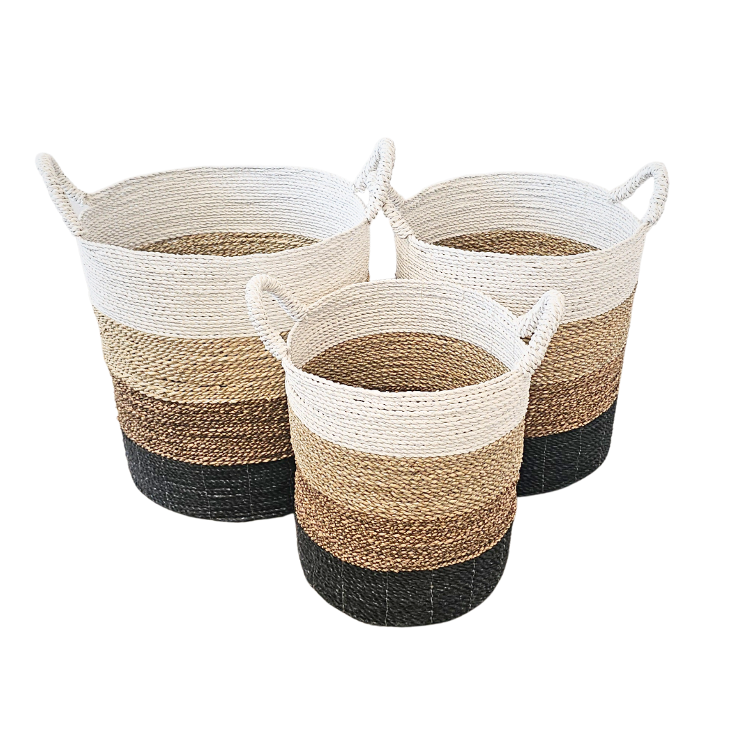 Set of three Calanque Seagrass Baskets in gradient white, natural, and black.