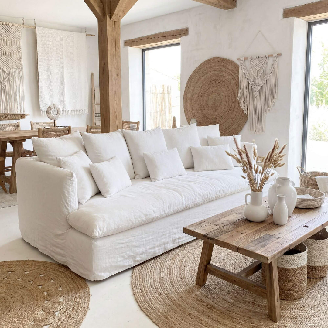 Cozy living room with a white Cala bianca sofa, wooden coffee table, and decorative elements.