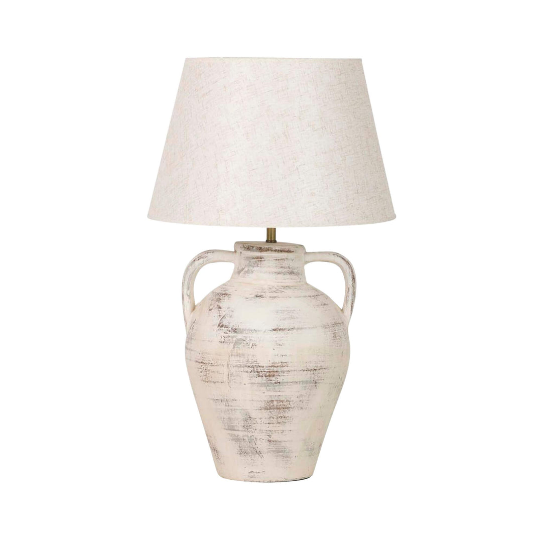 Front view of the Cala table lamp showing its aged ceramic amphora-style base and soft textile shade.