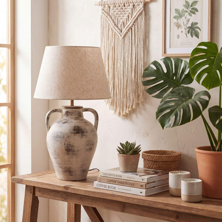 Styled interior setting featuring the Cala table lamp on a wooden console in a warm natural space.