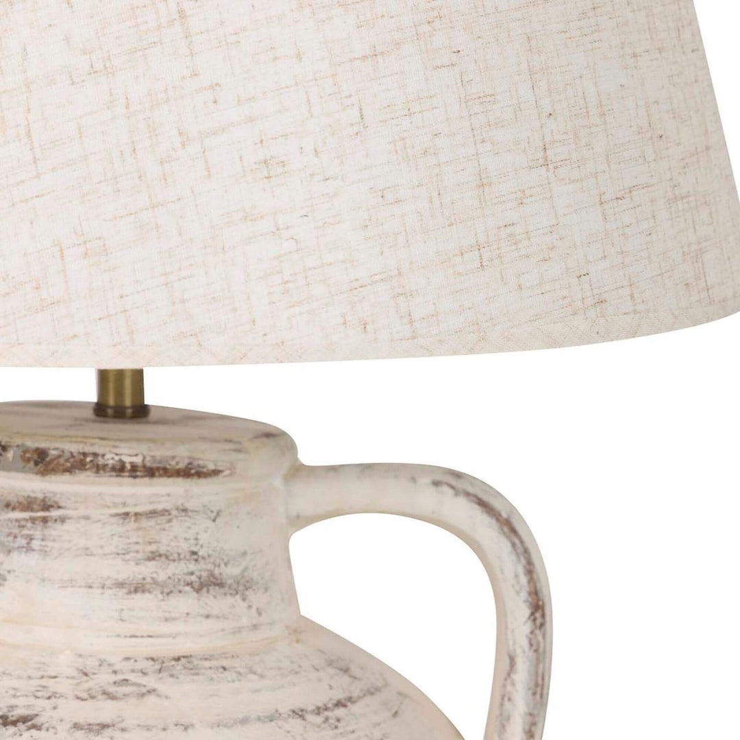 Close-up detail of the textile lampshade and ceramic handle showing the aged handcrafted finish.