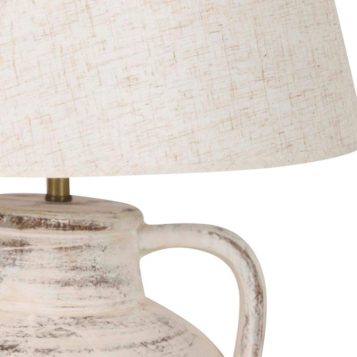 Close-up detail of the textile lampshade and ceramic handle showing the aged handcrafted finish.
