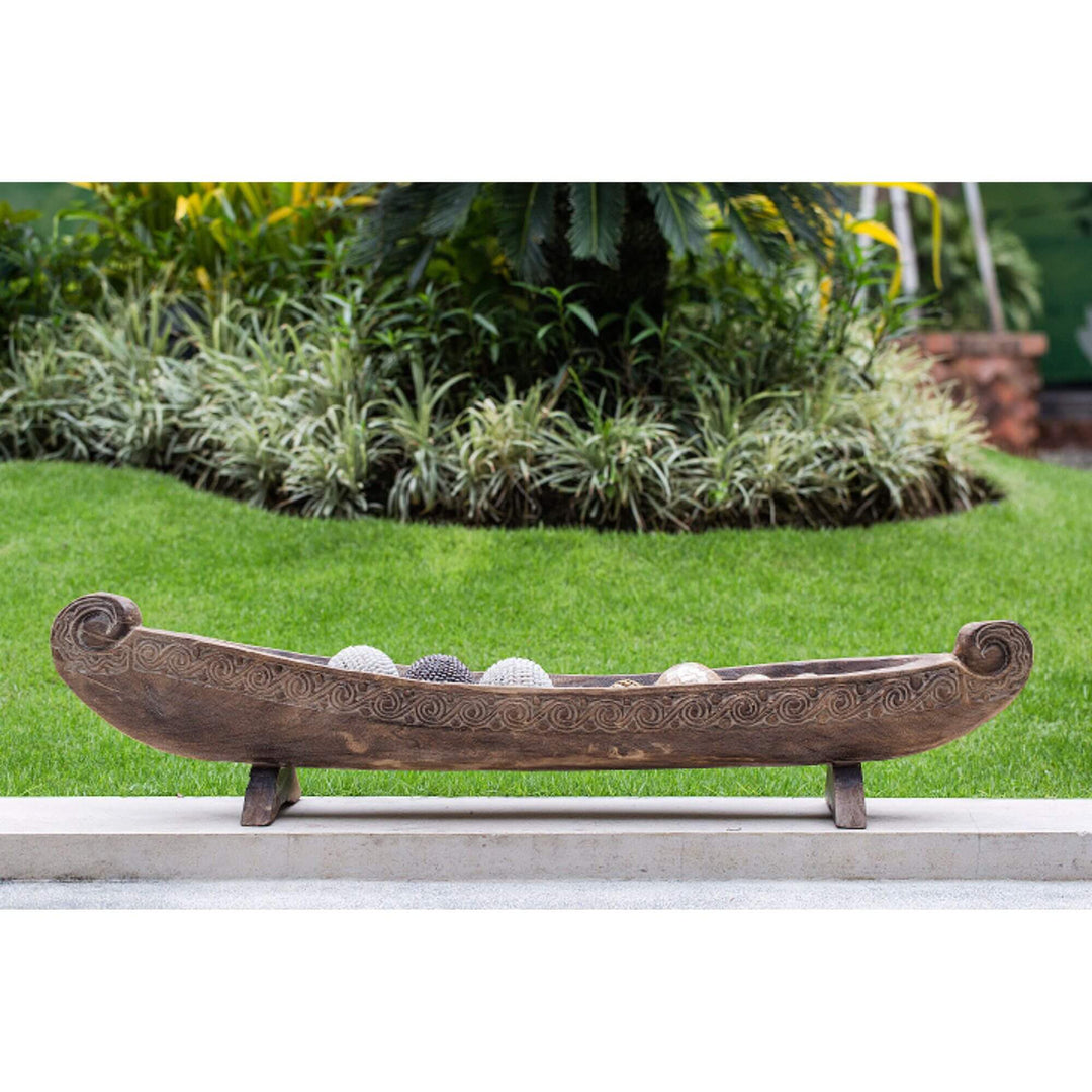Calypso teak boat decor side view showing carved detailing and elongated shape