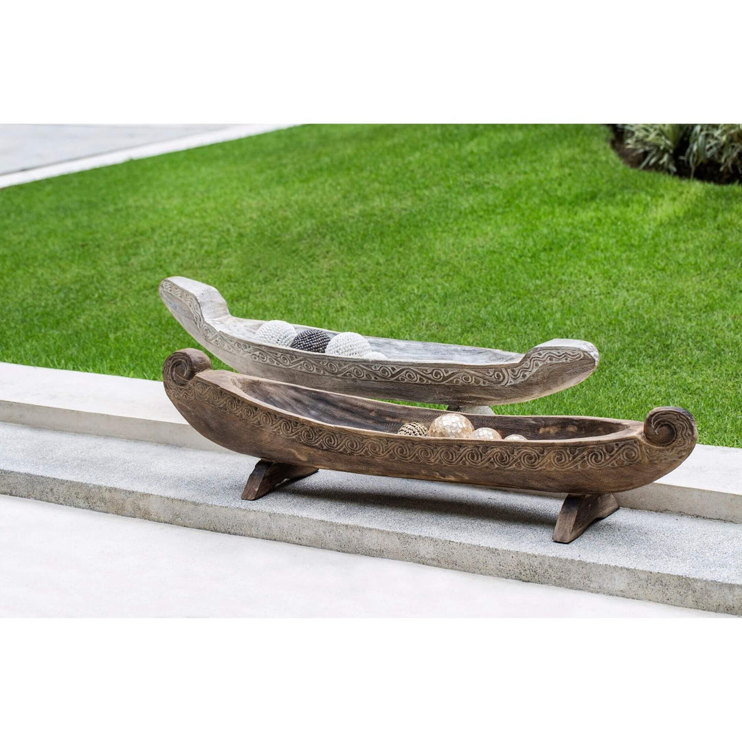 Calypso teak boat decor side view showing carved detailing and elongated shape