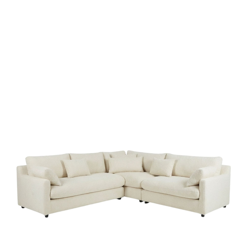 Front view of Capri Corner Sofa showcasing its clean lines and soft upholstered cushions.