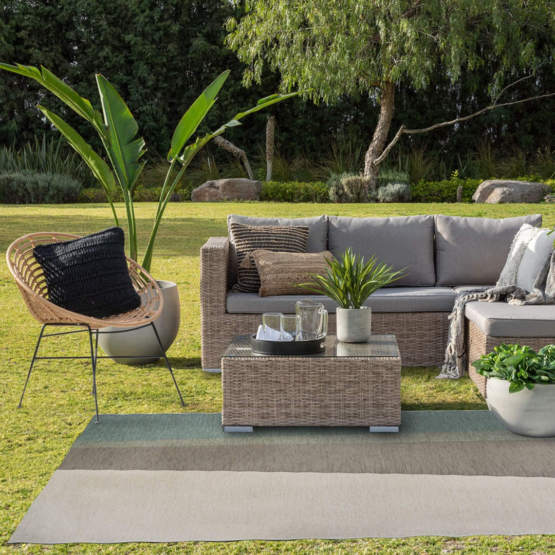 Outdoor lounge area featuring the Capri rug beneath a modular sofa.