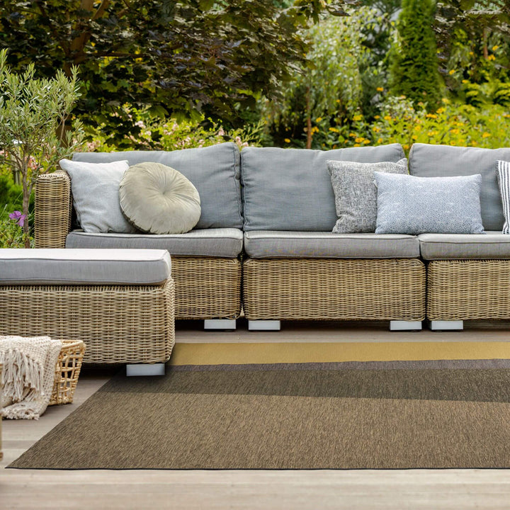Outdoor lounge area featuring the Capri rug beneath a modular sofa.