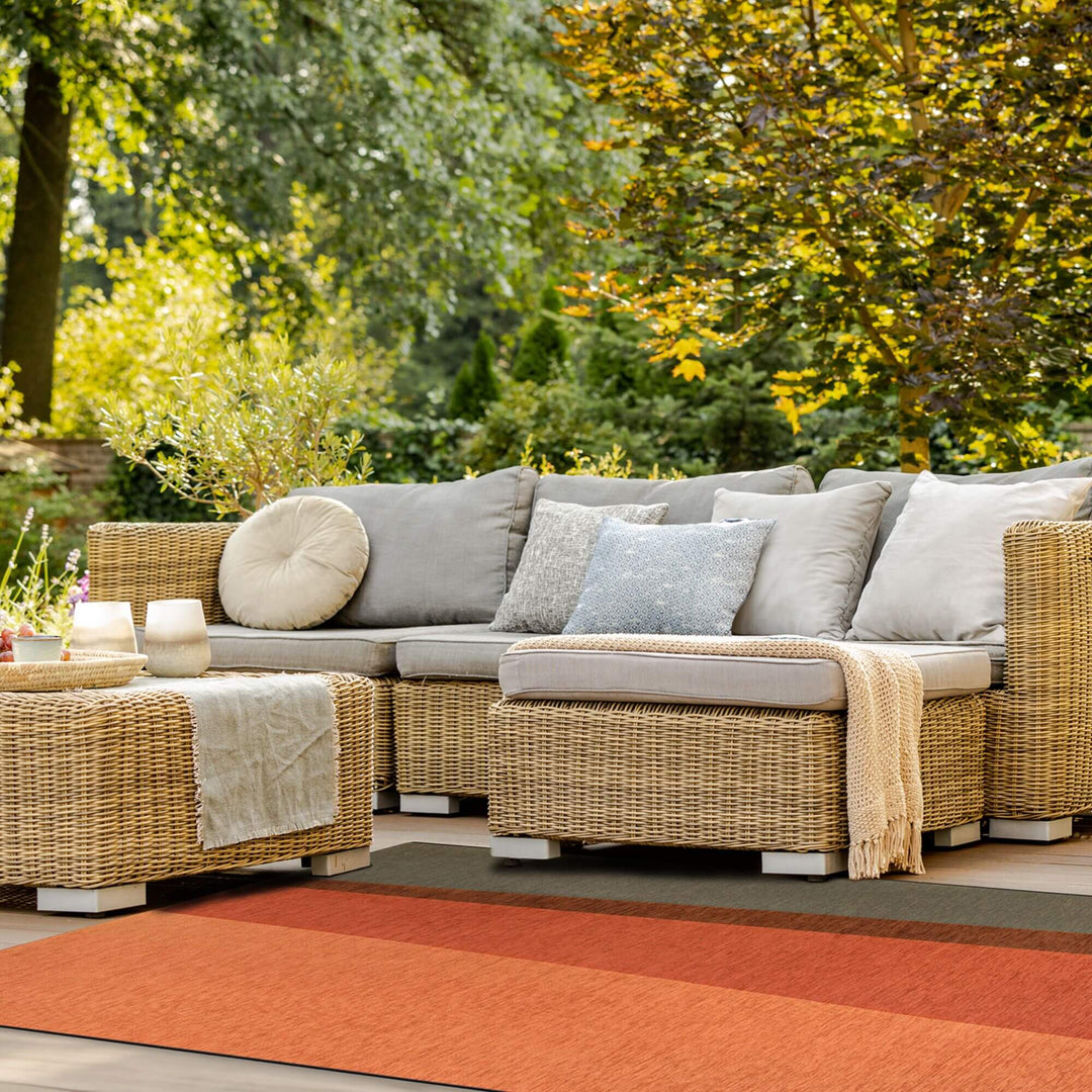 Outdoor lounge area featuring the Capri rug beneath a modular sofa.