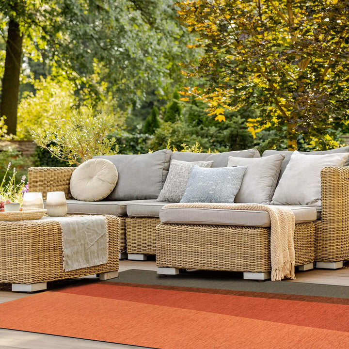Outdoor lounge area featuring the Capri rug beneath a modular sofa.