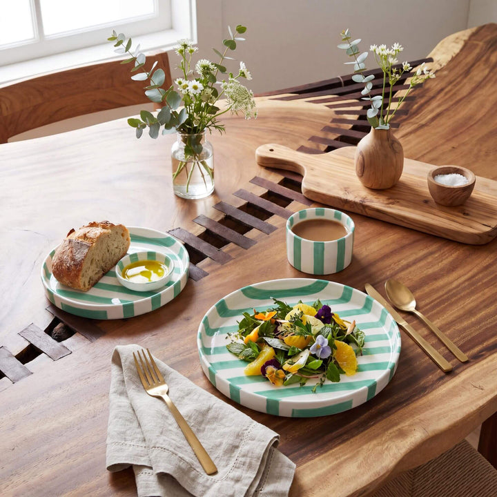 Styled dining table setting featuring the Capri Stripes plates in a fresh Mediterranean-inspired arrangement.