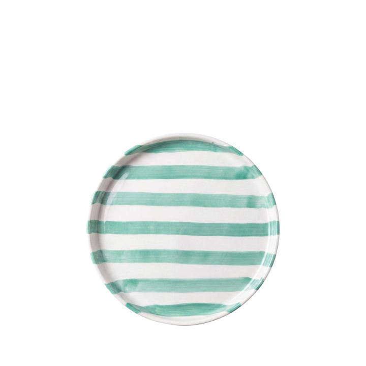Front view of the smaller round plate showing its green horizontal striped detail on a white ceramic base.