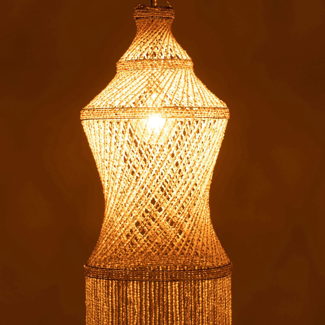 Caracoles ceiling lamp with a warm glow against a dark background