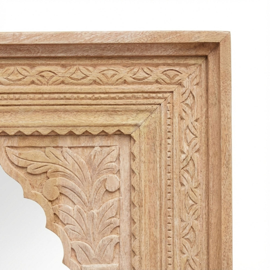 Detail view of the carved corner of the White Briss Collection mirror highlighting the intricate wood craftsmanship.