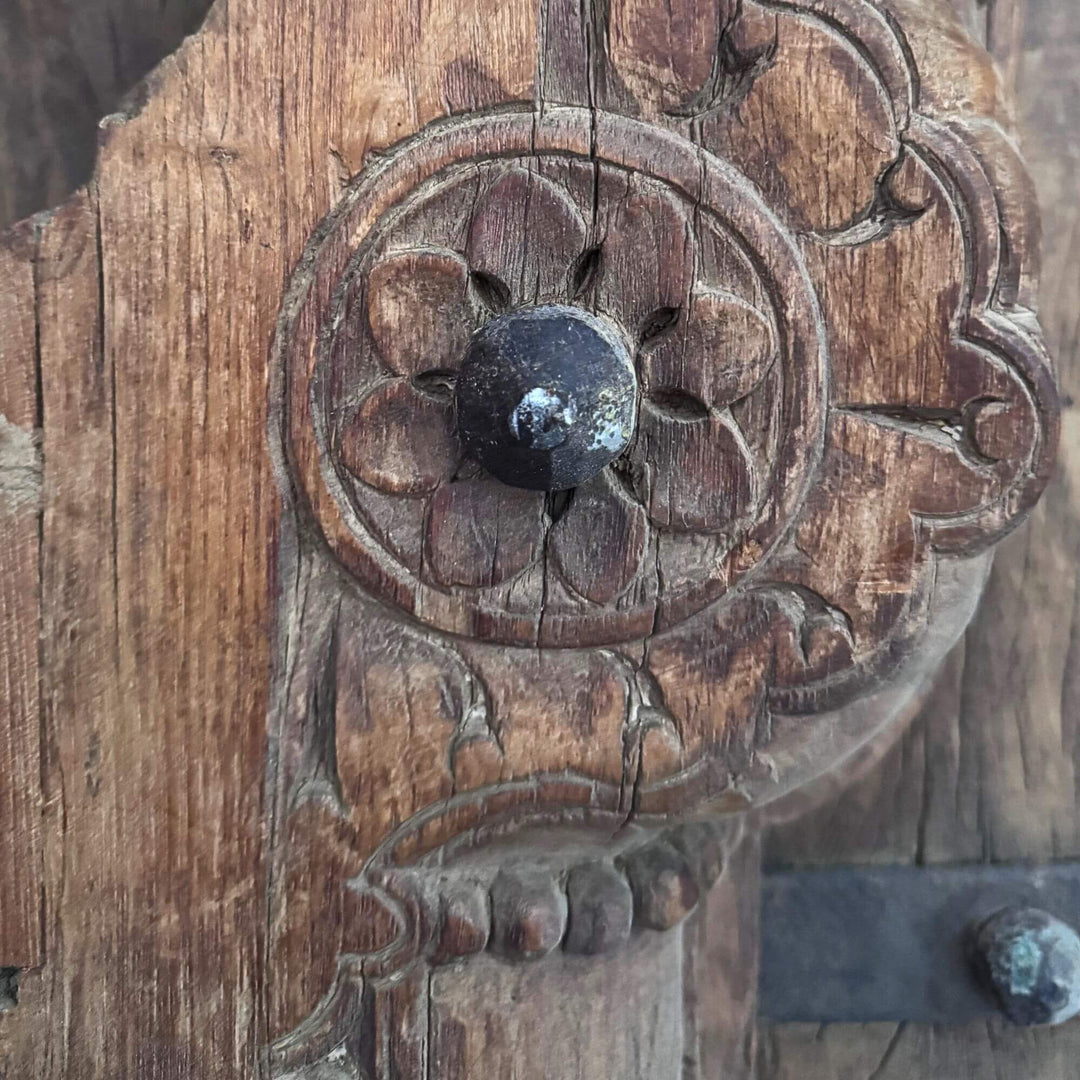 Detail of the Castle Door highlighting an ornate floral carving and sculpted sheesham wood ornament