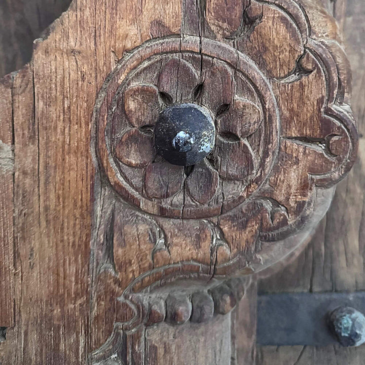 Detail of the Castle Door highlighting an ornate floral carving and sculpted sheesham wood ornament