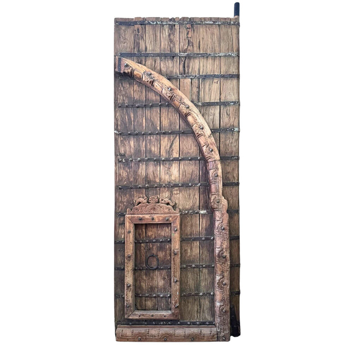 Front view of the right section of the Castle Door highlighting its carved arch and integrated smaller door