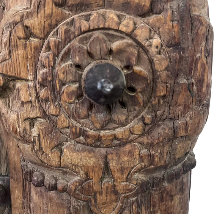 Close-up of the Castle Door showing an intricate floral carving and dark central metal stud