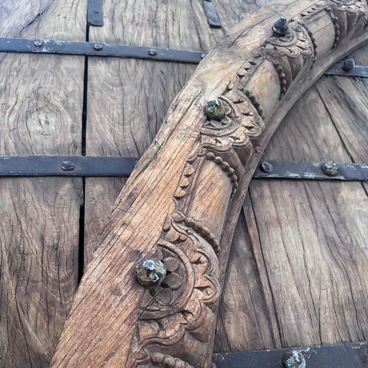 Detail of the Castle Door showing the ornate carved arch, floral motifs, and decorative metal studs