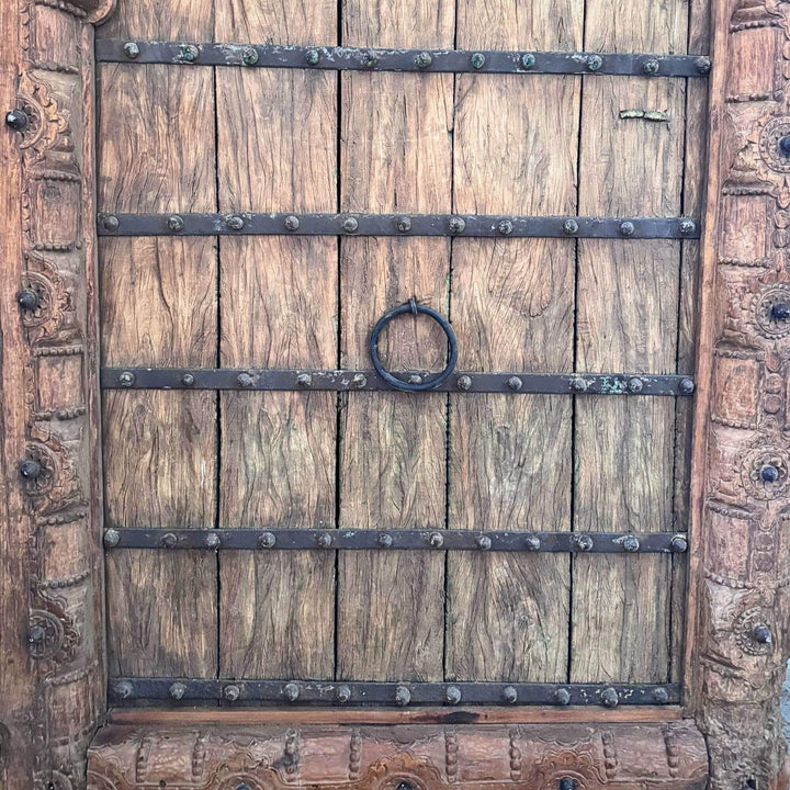 Front detail of a Castle Door panel showing weathered sheesham wood and traditional ring handle