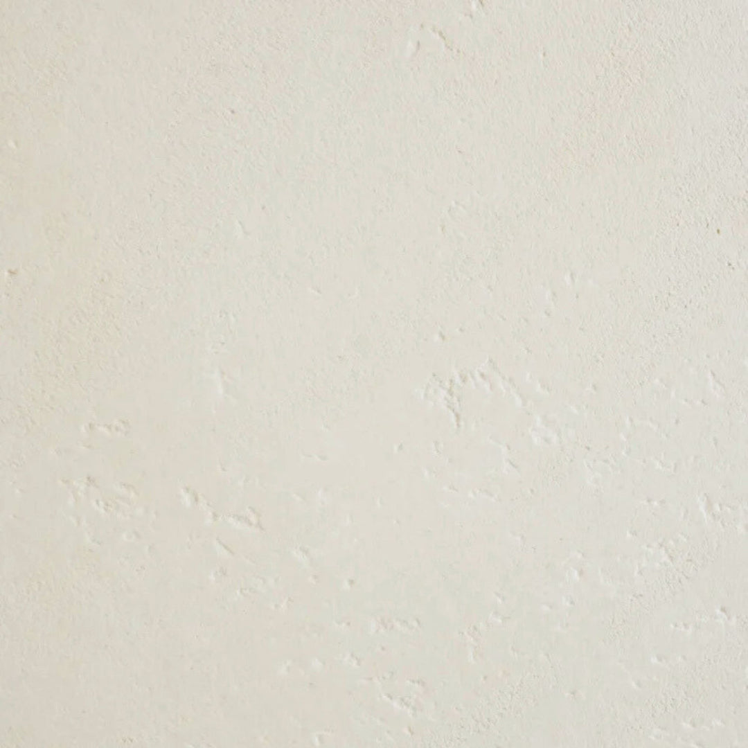 Close-up detail of the microcement finish showing subtle texture and natural surface variations.