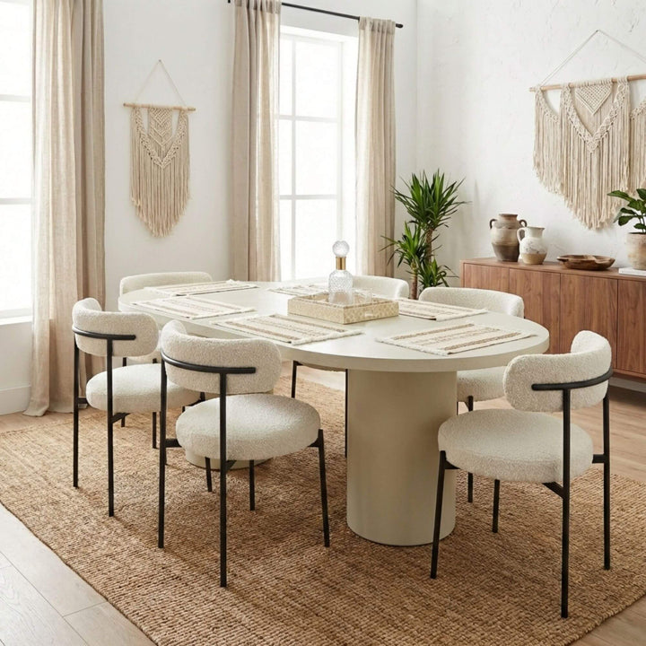 Styled dining room setting featuring the Cementique table paired with upholstered chairs and neutral decor.