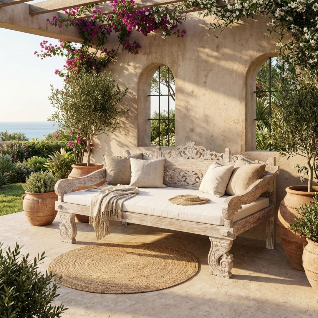 Outdoor terrace view of the Ceres teak daybed emphasizing its sculptural presence and relaxed seating design.