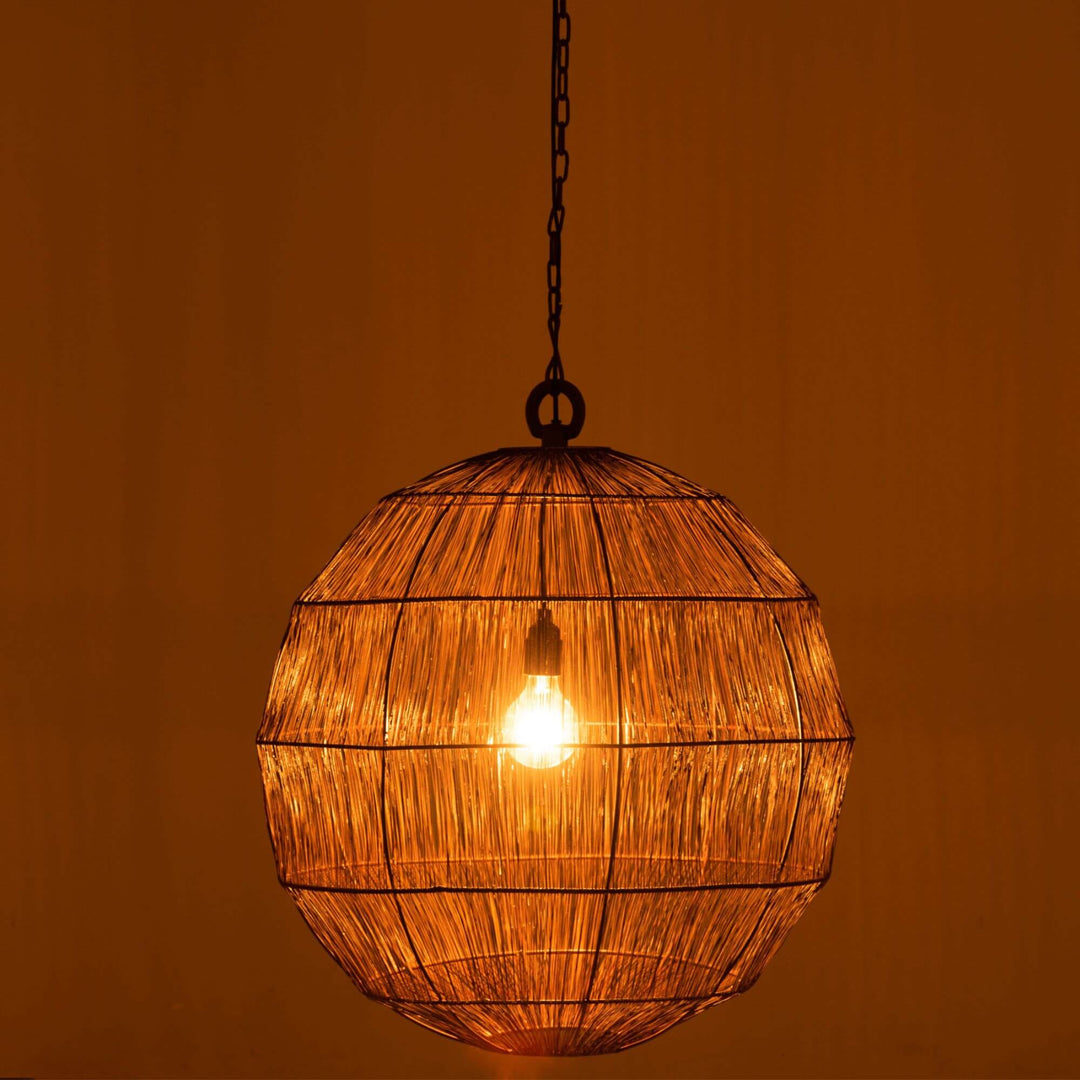 Industrial ceiling lamp glowing warmly in a dark room