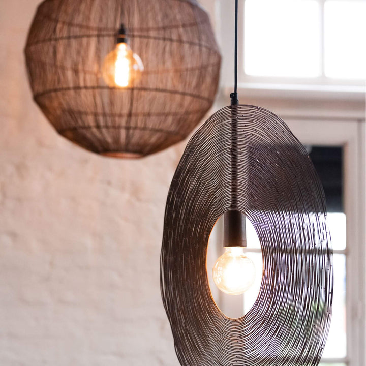 Close-up of metal round ceiling lamp hanging in interior decor