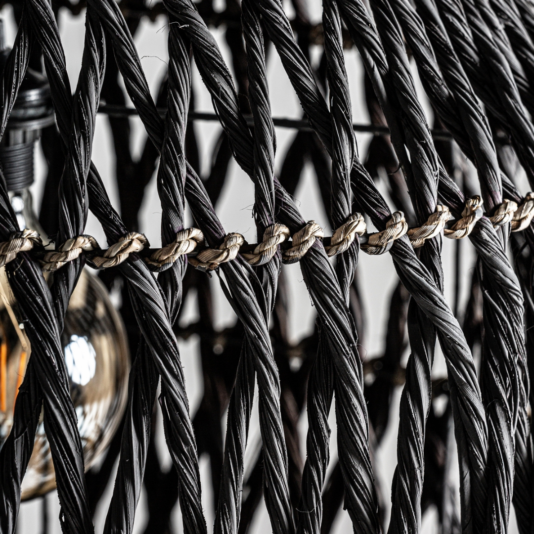 Close-up of handwoven black natural fibers on Charon lamp design.