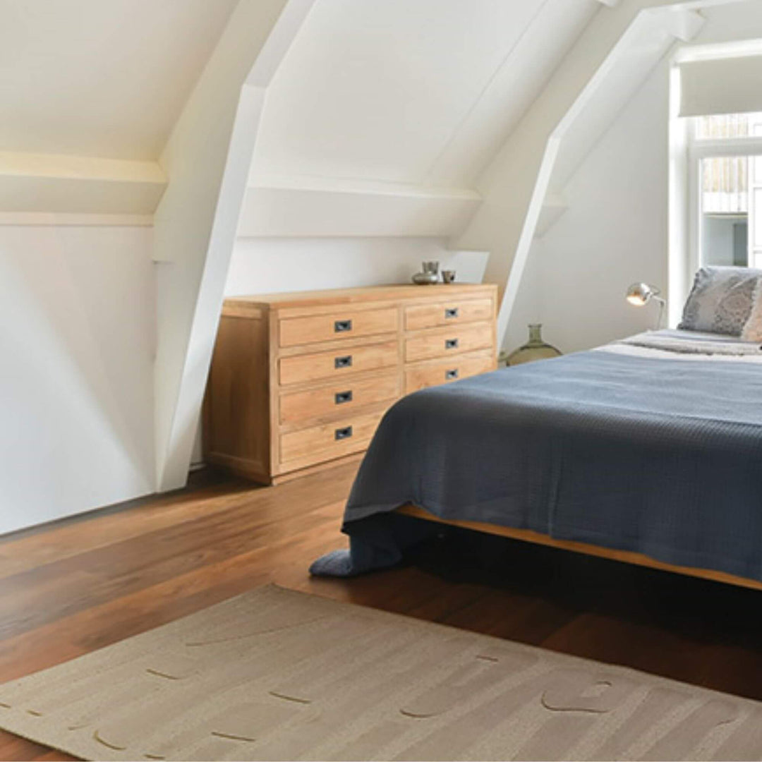 Bedroom interior featuring the Chiara Horizon rug under a wooden bed frame.