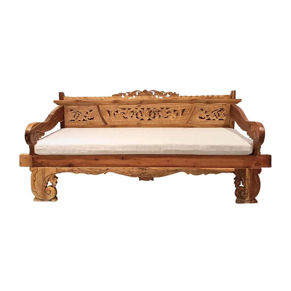 Carved teak daybed with cushion for indoor or covered outdoor lounging