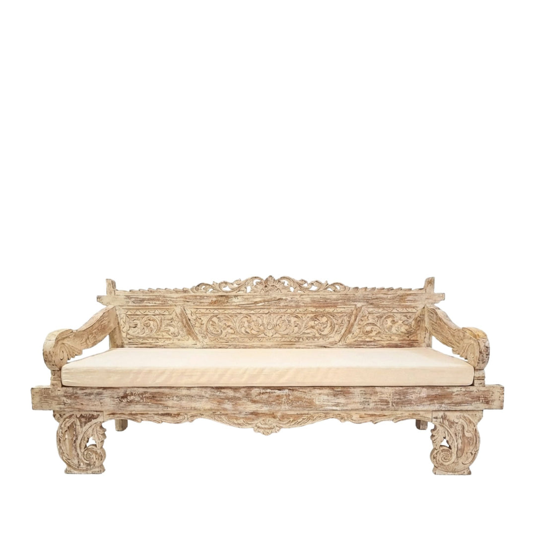 Chloe indonesian carved teak wood daybed with cream cushion on a white background