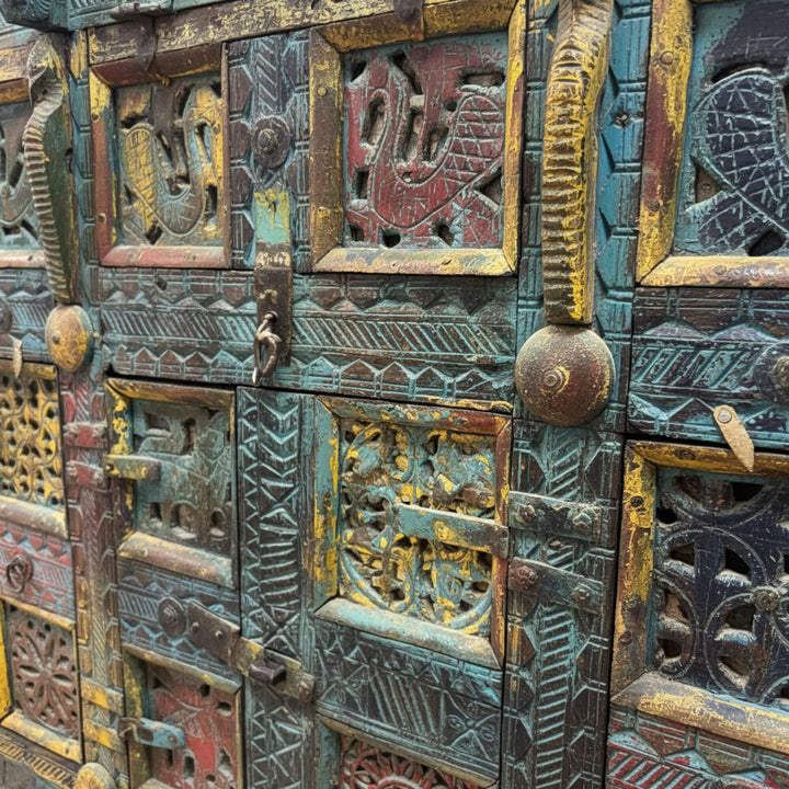 Close-up of the carved wooden panels with colorful antique patina.