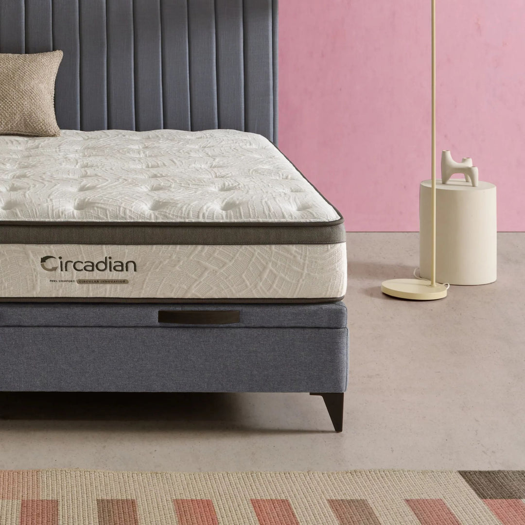 Angled bedroom shot highlighting the mattress profile and premium fabric texture.