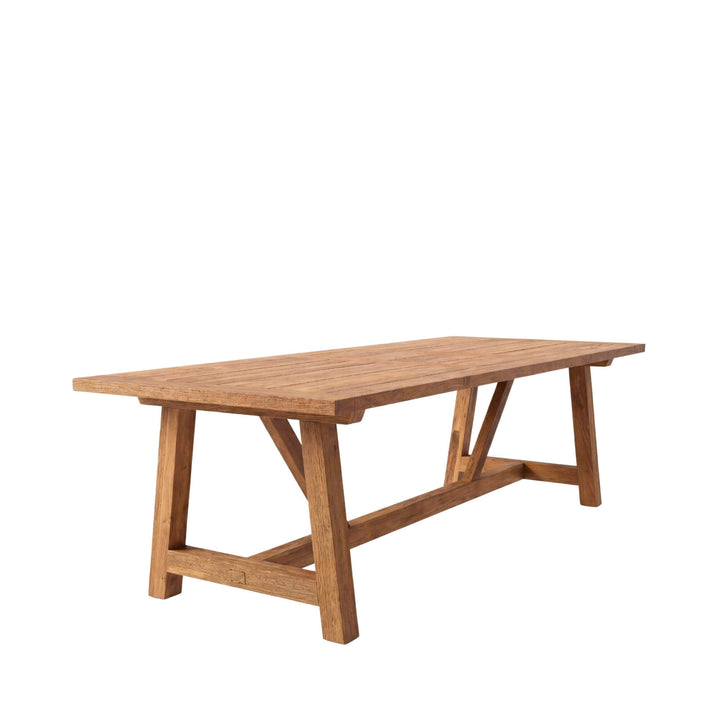 Front view of the Classic teak dining table showing its recycled teak wood structure and timeless rustic design.