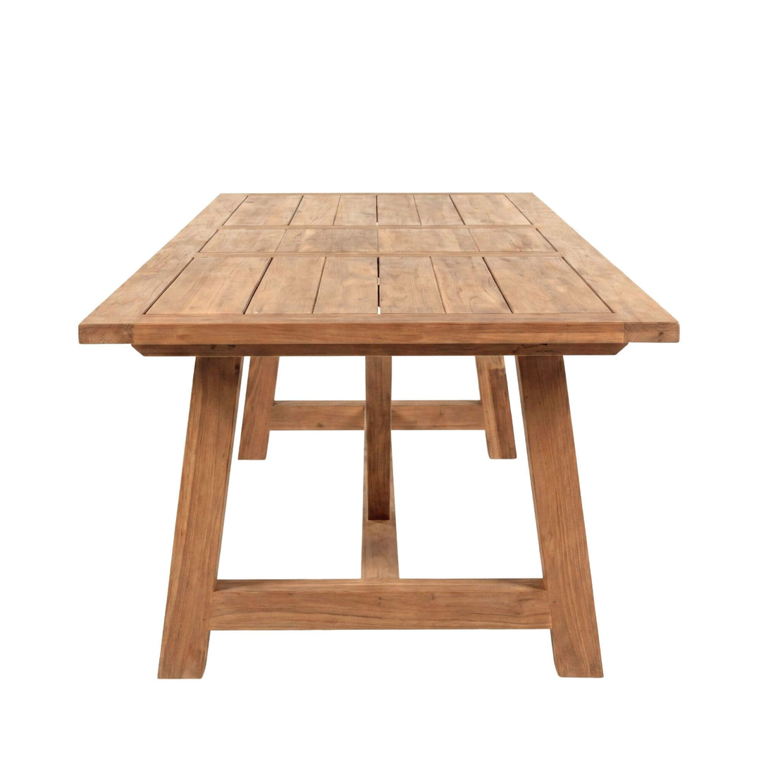 Front view of the dining table highlighting its generous proportions and sturdy teak frame.