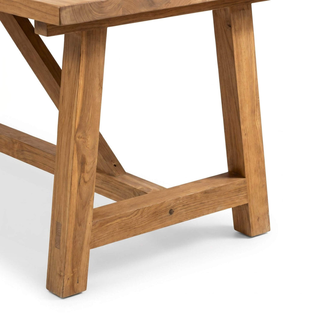 Close-up detail of the table leg and support structure showing the aged recycled teak texture.