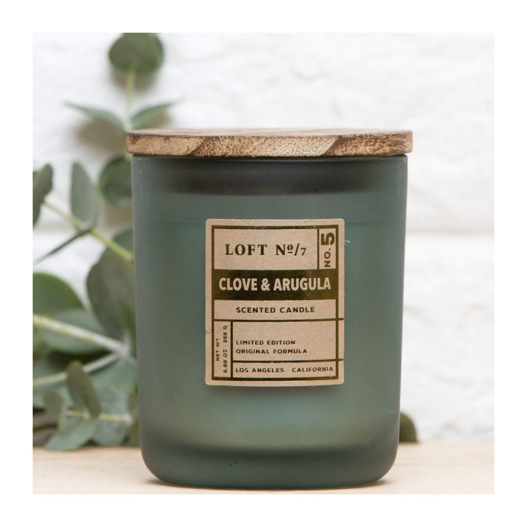 Front view of Clove & Arugula scented candle in green glass with wooden lid