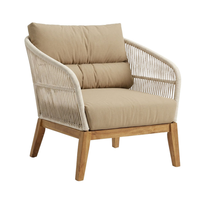 Angled view showing the curved armrests and natural rope detailing of the COCO armchair.