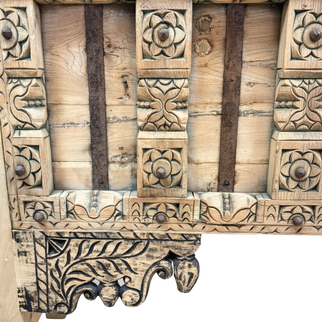 Detail of the carved front panels and decorative wooden motifs.