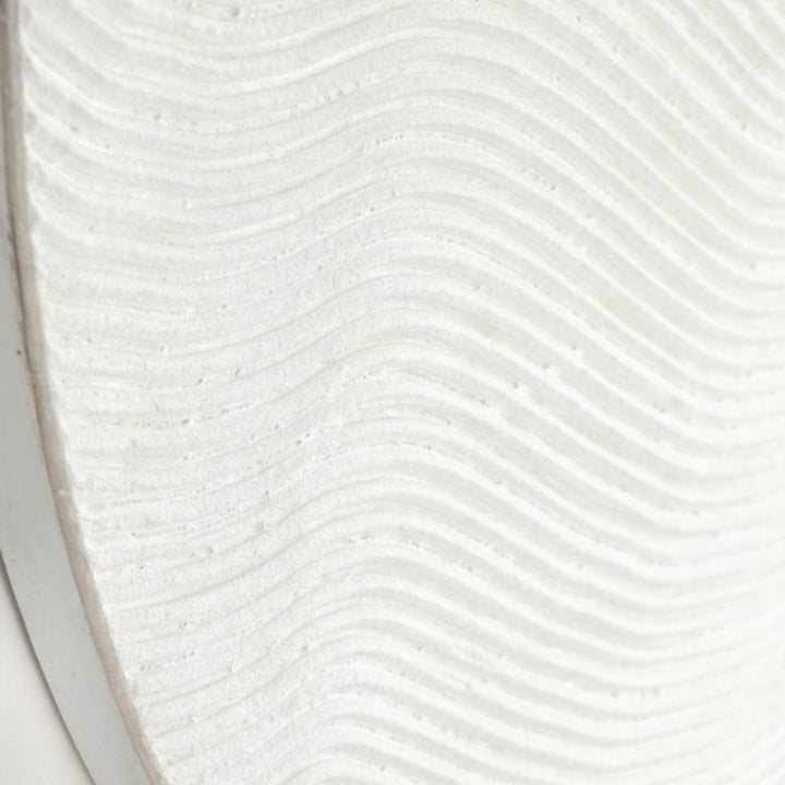 Close-up detail highlighting the flowing carved lines on the linen canvas surface.