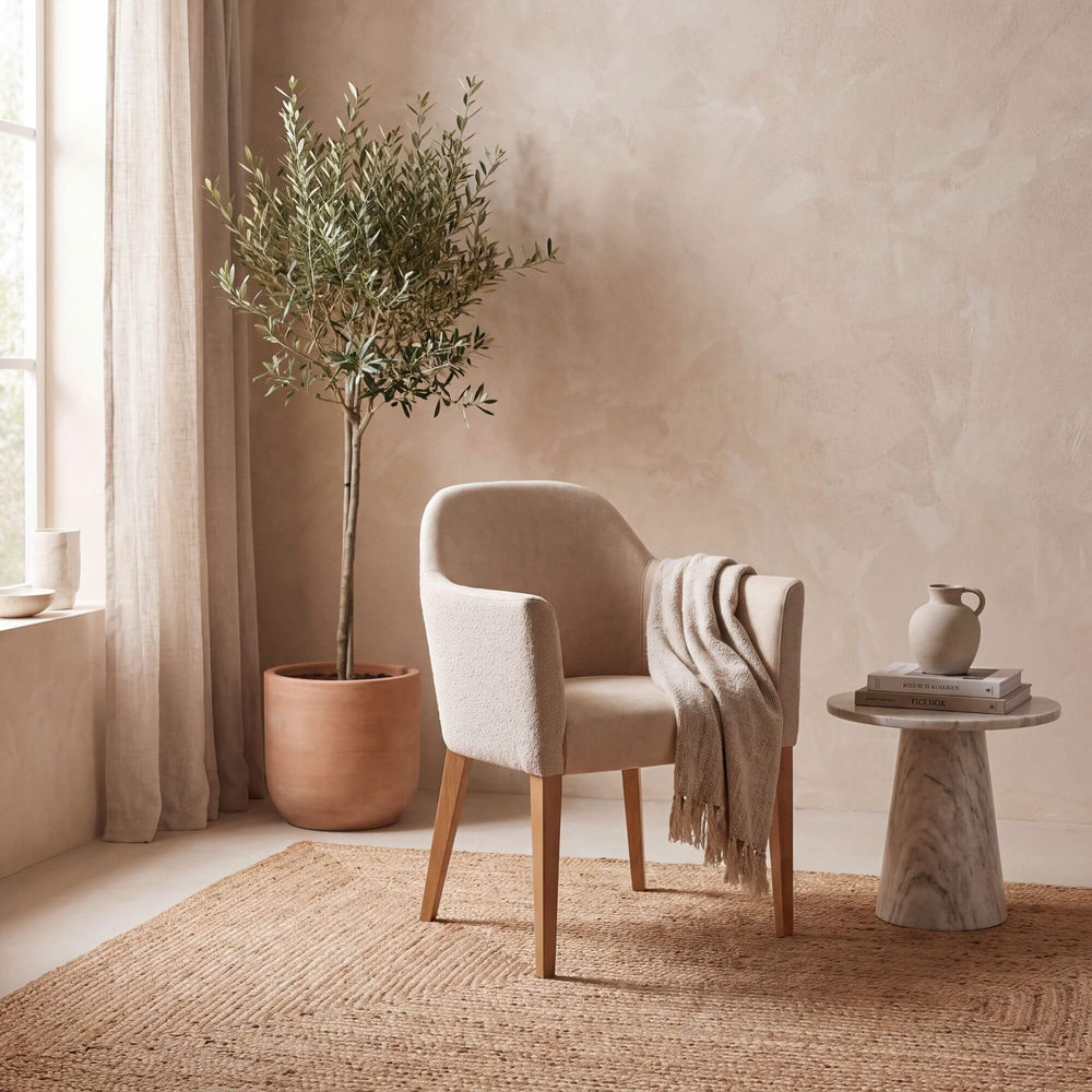 Cord Gracia upholstered armchair styled in a warm neutral interior with natural textures and Mediterranean-inspired decor